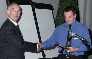 Damian Adams being presented with his Prize